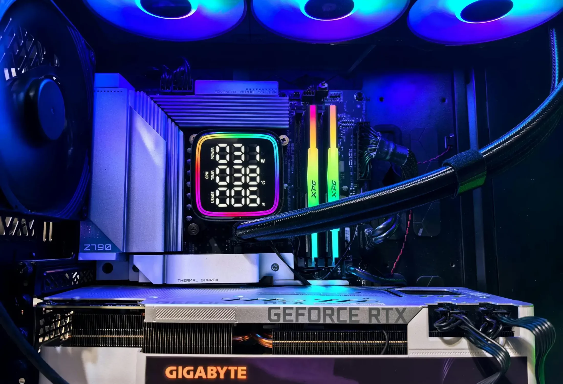 Vibrant RGB-lit gaming PC interior showcasing GeForce RTX and GIGABYTE components.